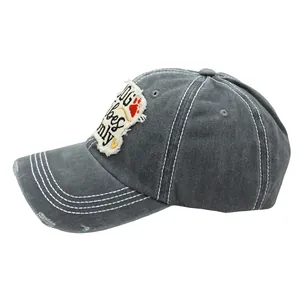 Detail of grey washed cotton baseball cap with DOG vibes ONLY patch and ripped brim