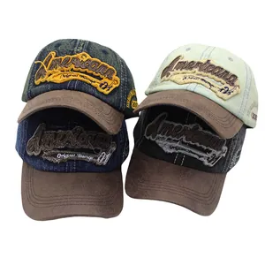 Detail of Americana vintage baseball caps in washed denim with suede brims and embroidery
