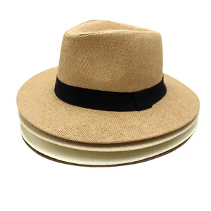 Close-up of stacked mesh straw fedora hats in natural colors with black ribbon bands