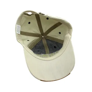 Detailed interior of washed cotton baseball cap with cotton label and metal buckle adjustment