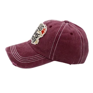 Detailed view of the distressed brim and vintage vibes embroidery on the cotton baseball cap