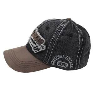 Detailed close-up of retro washed denim baseball cap with side vintage embroidery