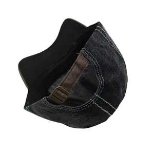 Detail of vintage washed denim baseball cap with white contrast stitching and leather strap