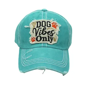Detailed view of teal cotton baseball cap with distressed DOG Vibes Only embroidery