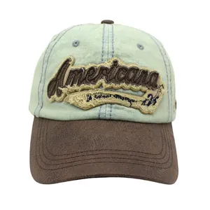 Detail of Americana embroidery on vintage washed denim and brown leather baseball cap