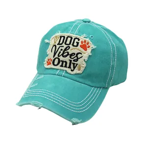 Close-up of distressed cotton baseball cap with DOG Vibes Only embroidery and frayed brim