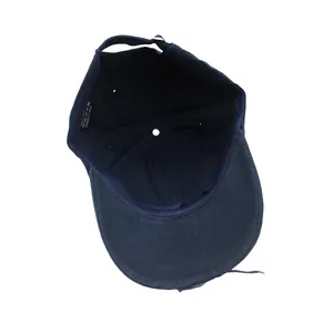 Detail view of cotton washing label and adjustable strap on dark blue baseball cap