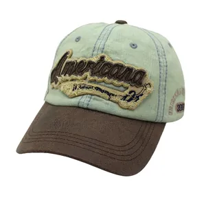 Close-up of vintage American embroidery on washed denim and leather baseball cap