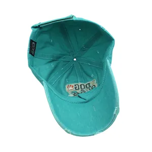 Macro shot of 100% cotton washed label and distressed inner embroidery on green baseball cap
