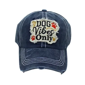 Detail of DOG Vibes Only patch embroidery and distressed holes on navy cotton baseball cap