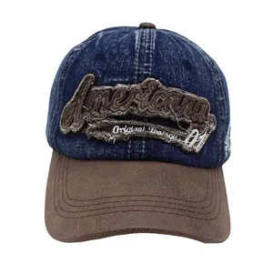 Detail of vintage navy denim baseball cap with Americana embroidery and brown suede brim