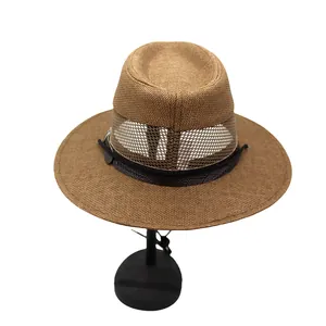 Detail of a brown woven straw hat showing the breathable mesh layer and black band