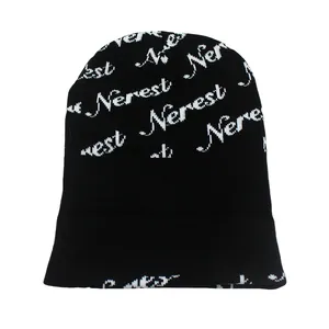 Detailed close-up showing the Nerest jacquard letter pattern on the black knit beanie hat