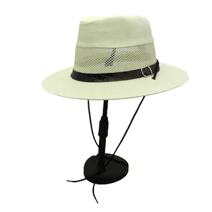 Close-up of beige woven fedora with breathable mesh, crocodile strap, and chin cord