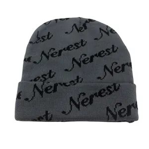 Close-up of the grey knitted beanie with repeating black Nerest jacquard letter patterns