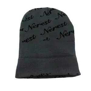 Close-up of the dark grey knitted beanie featuring black Nerest letter jacquard pattern
