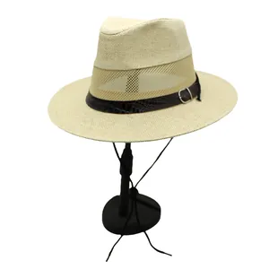 Detail of beige straw hat featuring mesh ventilation and brown crocodile texture band