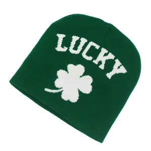 Detail of green knitted lucky shamrock beanie with white clover pattern jacquard texture