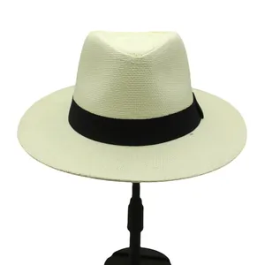 Detailed texture of cream woven straw fedora hat with a classic black ribbon band