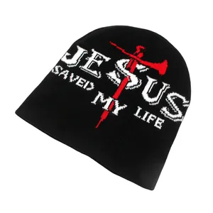 Black knit beanie featuring white JESUS letters and red cross graphic for winter warmth