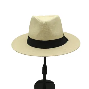 Detail of breathable straw fedora featuring a classic black ribbon and woven texture