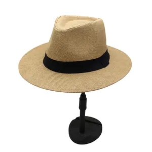 Close-up of khaki straw Panama hat featuring fine mesh texture and a black ribbon band
