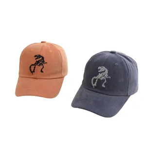 Detailed embroidery of dinosaur skeleton on orange and navy cotton baseball caps