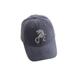Detailed close-up of white dinosaur skeleton embroidery on dark grey vintage baseball cap
