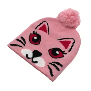 Gros plan sur un bonnet en maille rose avec motif chat mignon et détail pompon doux