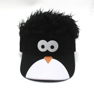 Detail view of novelty visor hat featuring black afro wig and cartoon penguin embroidery