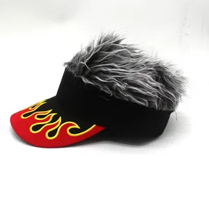 Macro view of visor hat featuring silver wig hair and flame embroidery on red brim