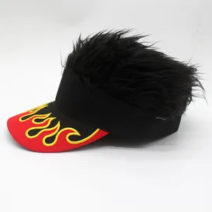 Close-up of black wig sun visor hat with red brim featuring yellow flame embroidery