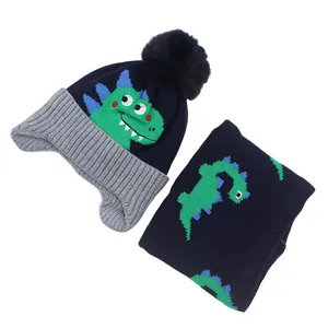 Kids navy knit hat and scarf set with green dinosaur jacquard and gray ribbed trim