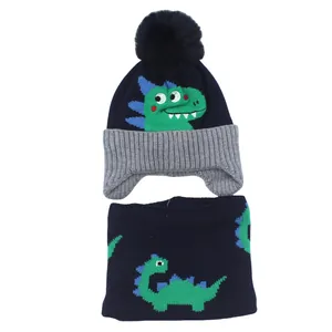 Detail of navy knit hat and scarf set with cartoon dinosaur pattern and thick fleece lining