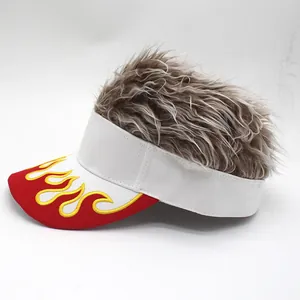 Detail of wig visor hat featuring red brim with flame embroidery and brown synthetic hair