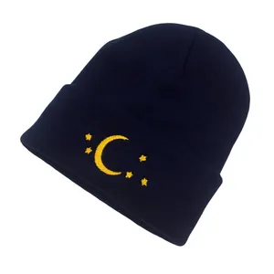 Detailed embroidery of yellow moon and stars on dark blue ribbed knit beanie hat