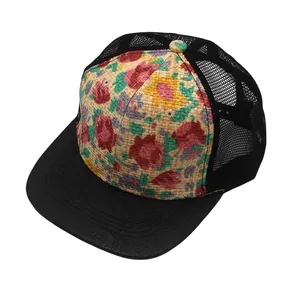 Close-up of floral print woven panel and breathable black mesh on a trucker baseball cap