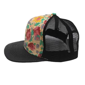 Detail of floral straw weave panel and black mesh back on this stylish trucker hat