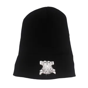 Detail shot of black knitted beanie with high-quality white animal mascot embroidery