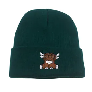 Dark green ribbed knit beanie featuring a cute highland cow embroidery on the cuff