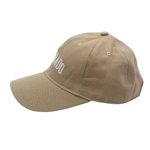 Detailed view of white letter embroidery on khaki cotton kids baseball cap