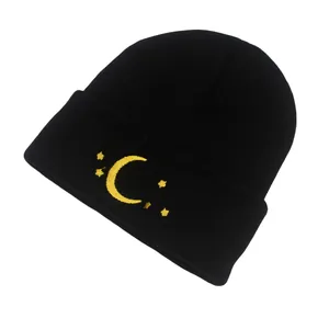 Detailed view of yellow moon and star embroidery on black ribbed knit beanie hat