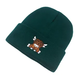 Close-up of fine ribbed knit texture and cute highland cow embroidery on beanie