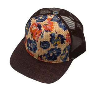 Floral straw trucker hat with breathable mesh and brown leather brim in a 45-degree view