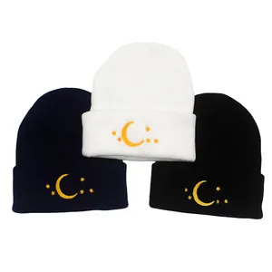 Knitted beanie hats with crescent moon and star embroidery in navy, white and black colors