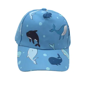 Detail of blue kids baseball cap featuring cartoon whale patterns and breathable cotton fabric