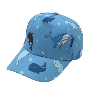 Detail of blue kids baseball cap with cute cartoon whales and nautical sea life patterns