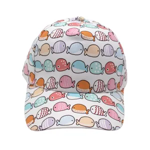 Detail of white kids baseball cap featuring colorful all-over cartoon fish patterns