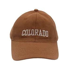 Detailed view of white Colorado letter embroidery on a brown cotton canvas baseball cap