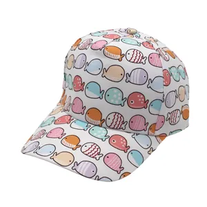 Close-up of kids baseball cap with colorful cartoon whale and fish patterns on white fabric
